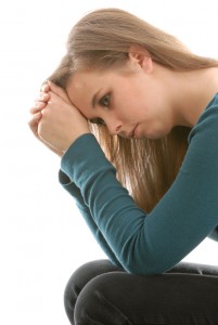 teenage depression - teen woman sitting thinking