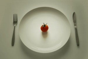 tomato single on a plate cutlery