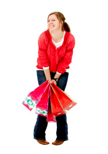 Happy woman with shopping bags isolated over a white background