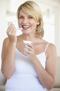 Mid Adult Woman Eating Yogurt